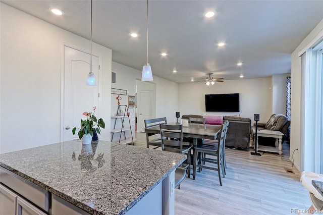 9448 Richfield St, Commerce City, CO 80022 - kitchen featuring light wood-style floors, ceiling fan, stone counters, recessed lighting, and a center island