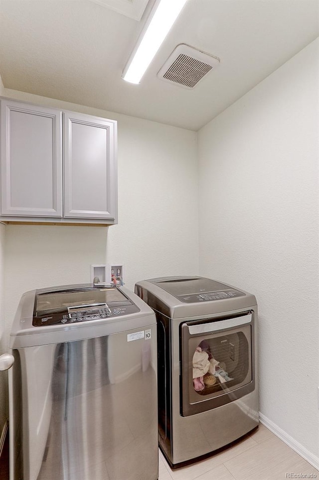 9448 Richfield St, Commerce City, CO 80022 - laundry area featuring cabinet space, washing machine and clothes dryer, and baseboards