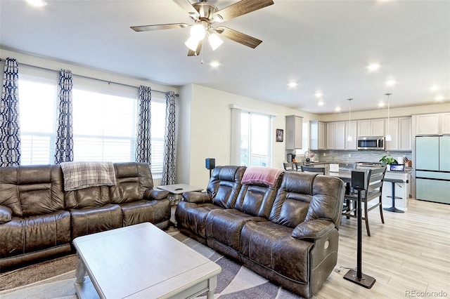 9448 Richfield St, Commerce City, CO 80022 - living area featuring plenty of natural light, ceiling fan, light wood-style floors, and recessed lighting