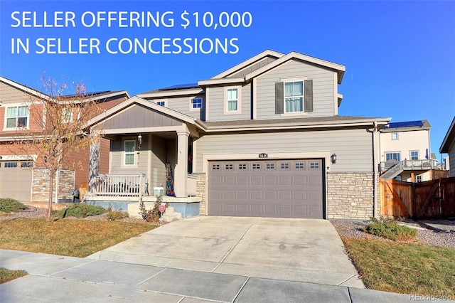 9448 Richfield St, Commerce City, CO 80022 - craftsman house with covered porch, an attached garage, stone siding, and concrete driveway