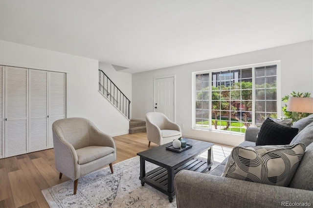3855 S Monaco St Unit 182, Denver, CO 80237 - living area featuring stairs, wood finished floors, and baseboards