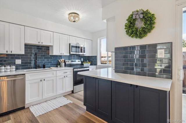 3855 S Monaco St Unit 182, Denver, CO 80237 - kitchen with appliances with stainless steel finishes, a sink, and white cabinetry