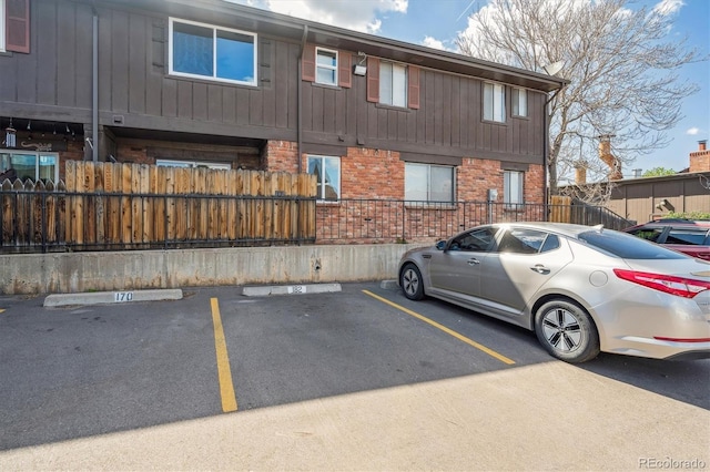 3855 S Monaco St Unit 182, Denver, CO 80237 - uncovered parking lot with fence