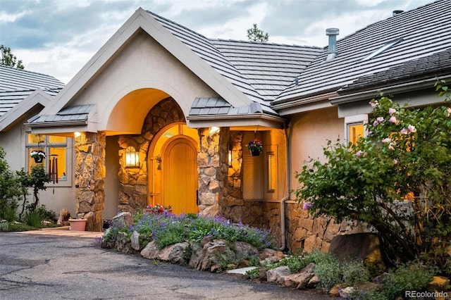 1426 Rembrandt Rd, Boulder, CO 80302 - property entrance with a standing seam roof, stone siding, stucco siding, and metal roof