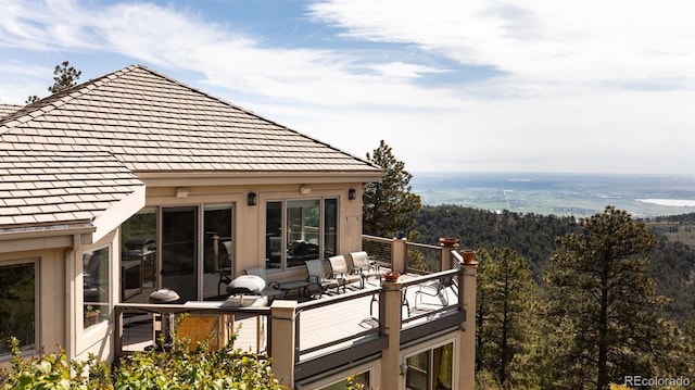 1426 Rembrandt Rd, Boulder, CO 80302 - view of property exterior with a balcony and a view of trees