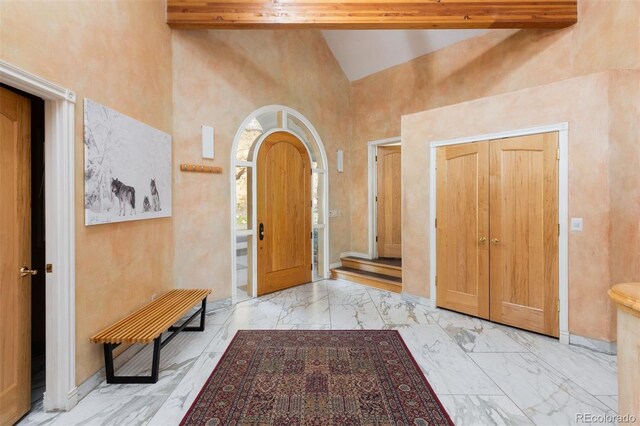 1426 Rembrandt Rd, Boulder, CO 80302 - entryway featuring marble finish flooring, high vaulted ceiling, and baseboards