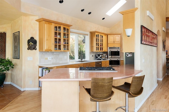 1426 Rembrandt Rd, Boulder, CO 80302 - kitchen with a sink, appliances with stainless steel finishes, lofted ceiling, tasteful backsplash, and light wood finished floors