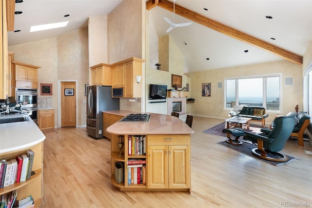 1426 Rembrandt Rd, Boulder, CO 80302 - kitchen with high vaulted ceiling, appliances with stainless steel finishes, light brown cabinetry, open floor plan, and light wood-type flooring