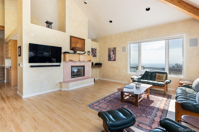 1426 Rembrandt Rd, Boulder, CO 80302 - living area featuring wood finished floors, a high end fireplace, high vaulted ceiling, and baseboards