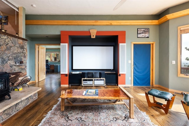1426 Rembrandt Rd, Boulder, CO 80302 - cinema with a wood stove, wood finished floors, and baseboards