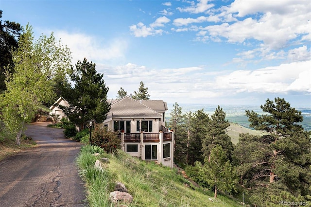 1426 Rembrandt Rd, Boulder, CO 80302 - obstructed view of property featuring a balcony, a water view, stucco siding, and a tiled roof