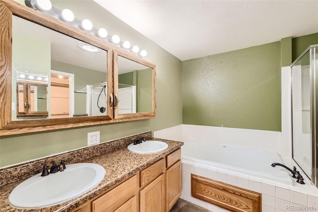 bathroom featuring vanity and shower with separate bathtub