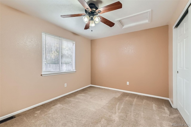 unfurnished room with light colored carpet and ceiling fan