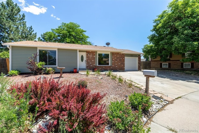 1394 S Zeno St, Aurora, CO 80017 - ranch-style house with concrete driveway, a garage, and brick siding