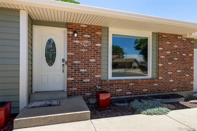 1394 S Zeno St, Aurora, CO 80017 - doorway to property with brick siding