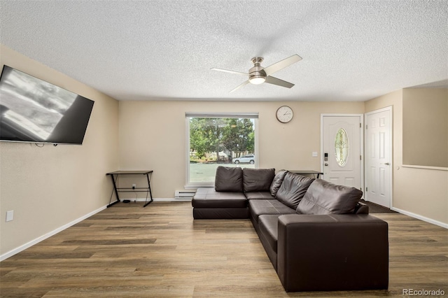 1394 S Zeno St, Aurora, CO 80017 - living area with ceiling fan, a baseboard radiator, wood finished floors, and a textured ceiling