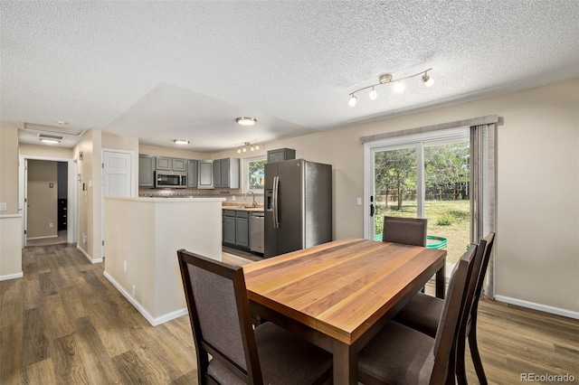 1394 S Zeno St, Aurora, CO 80017 - dining room featuring dark wood finished floors and a textured ceiling