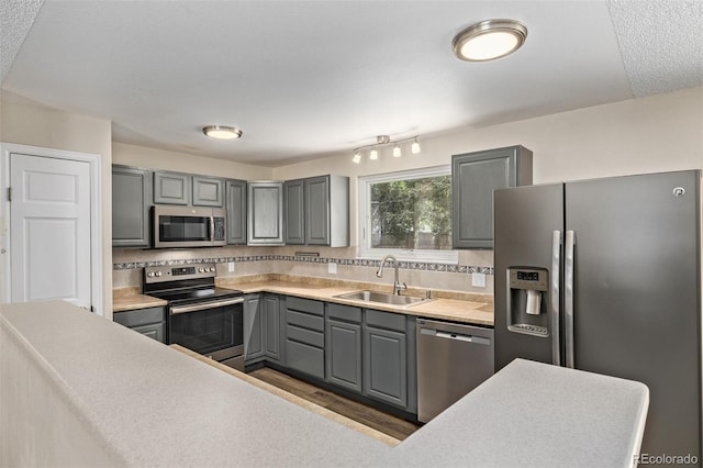 1394 S Zeno St, Aurora, CO 80017 - kitchen with stainless steel appliances, gray cabinets, decorative backsplash, and light countertops