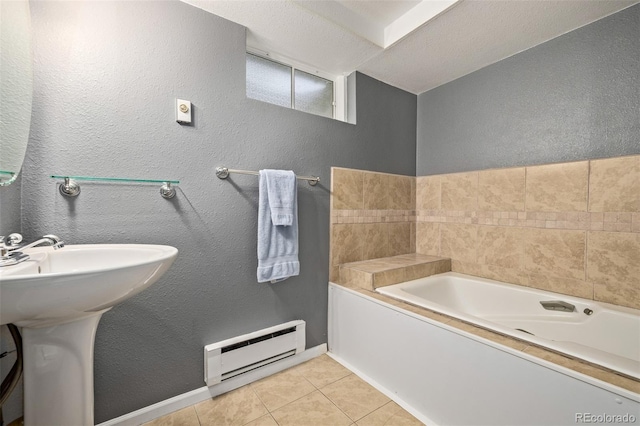 1394 S Zeno St, Aurora, CO 80017 - bathroom with a baseboard heating unit, a garden tub, tile patterned flooring, and a textured wall