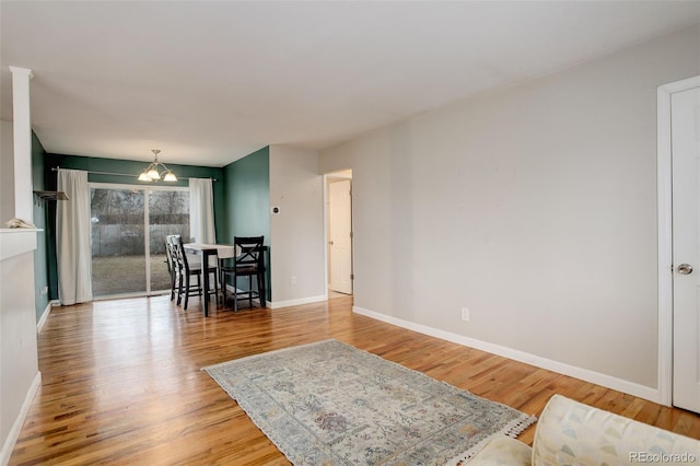 dining room with hardwood / wood-style floors and a notable chandelier