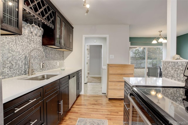 kitchen featuring an inviting chandelier, sink, decorative backsplash, appliances with stainless steel finishes, and decorative light fixtures