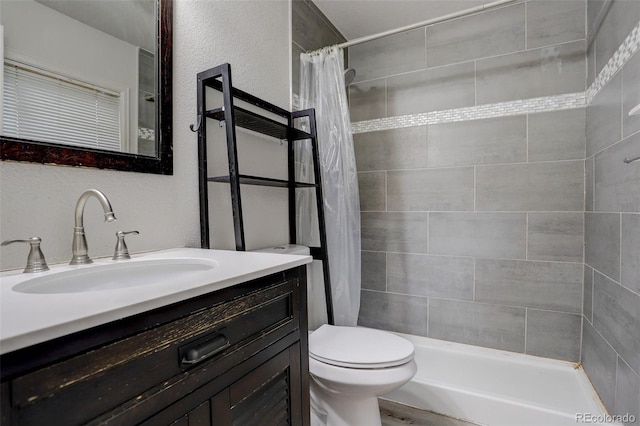 bathroom with a shower with shower curtain, vanity, and toilet