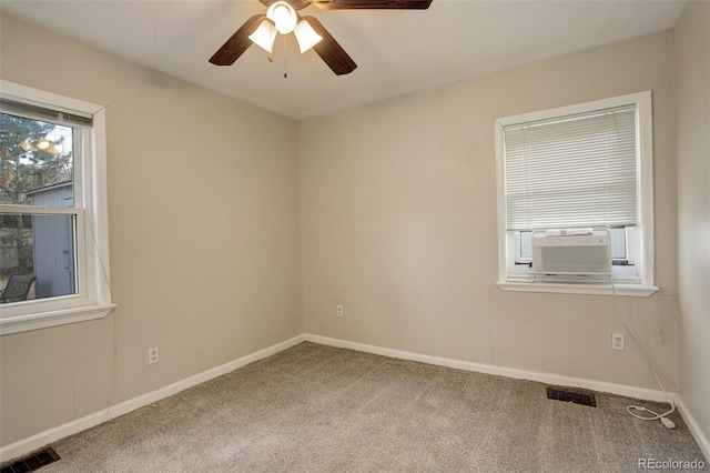 spare room featuring carpet floors, ceiling fan, and cooling unit