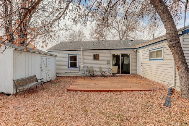 back of house featuring a shed and a deck