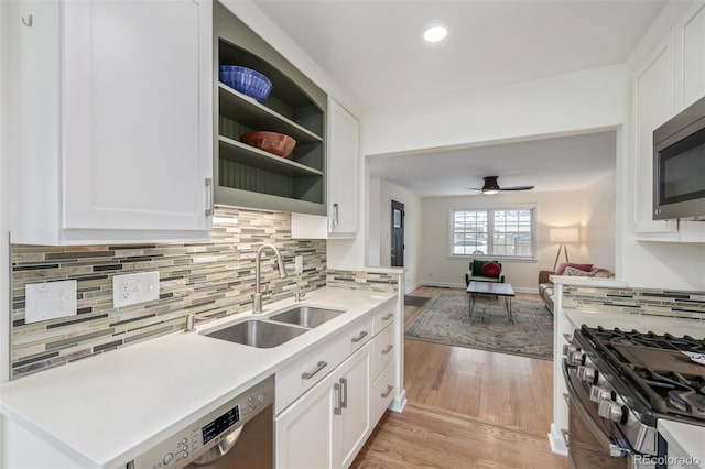 860 Magnolia St, Denver, CO 80220 - kitchen with light wood-style floors, appliances with stainless steel finishes, recessed lighting, and white cabinetry