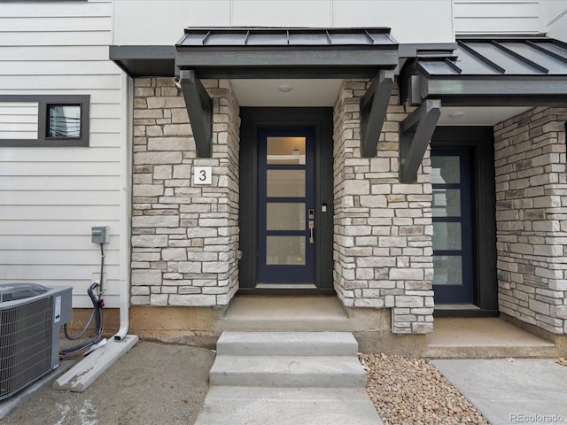 2032 S Holly St Unit 3, Denver, CO 80222 - doorway to property with a standing seam roof