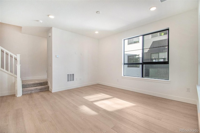 2032 S Holly St Unit 3, Denver, CO 80222 - spare room featuring light wood finished floors, stairs, and recessed lighting
