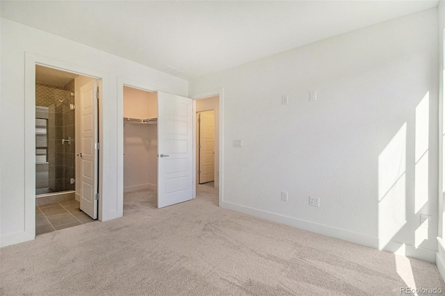2032 S Holly St Unit 3, Denver, CO 80222 - unfurnished bedroom with carpet floors, a walk in closet, a closet, and ensuite bath