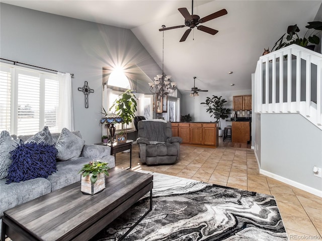 living room with light tile patterned floors, ceiling fan with notable chandelier, and vaulted ceiling