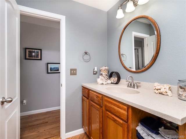 bathroom with hardwood / wood-style flooring and vanity