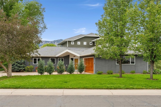 831 Crescent Dr, Boulder, CO 80303 - view of front of home with stucco siding, a front lawn, a mountain view, and a shingled roof