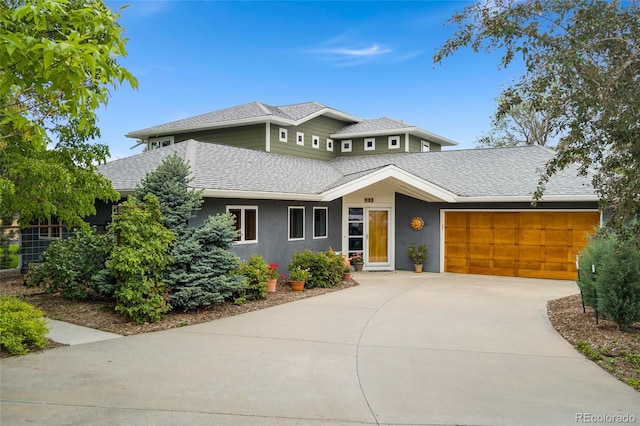 831 Crescent Dr, Boulder, CO 80303 - view of front of property featuring roof with shingles, a garage, concrete driveway, and stucco siding