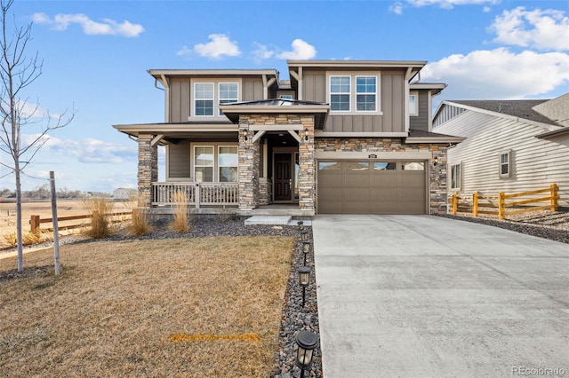 view of front facade featuring a porch, a garage, and a front yard