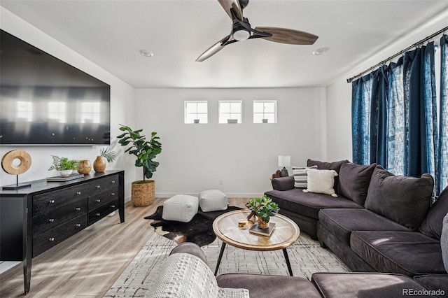 living room with ceiling fan and light hardwood / wood-style flooring