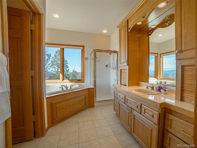 bathroom featuring a healthy amount of sunlight, separate shower and tub, and vanity