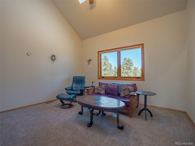 living area featuring high vaulted ceiling and carpet flooring