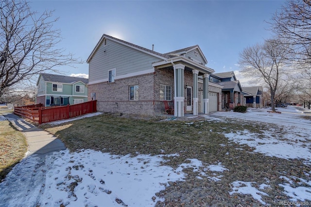 view of snowy exterior featuring a garage