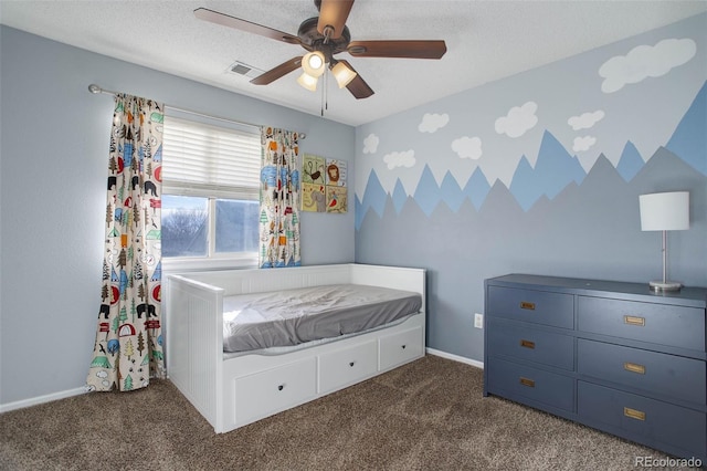 unfurnished bedroom with a textured ceiling, ceiling fan, and dark colored carpet