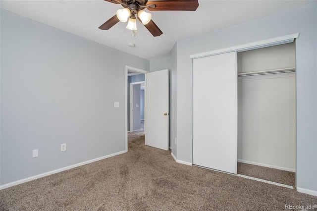 unfurnished bedroom featuring ceiling fan, a textured ceiling, a closet, and carpet floors