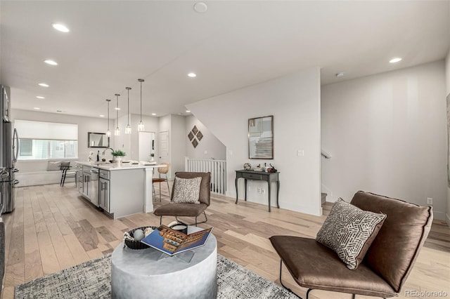 2052 Alcott Way, Broomfield, CO 80023 - living room featuring light wood finished floors, recessed lighting, and stairs