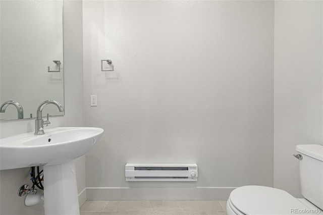 2052 Alcott Way, Broomfield, CO 80023 - half bath featuring toilet, baseboards, a baseboard radiator, and tile patterned flooring