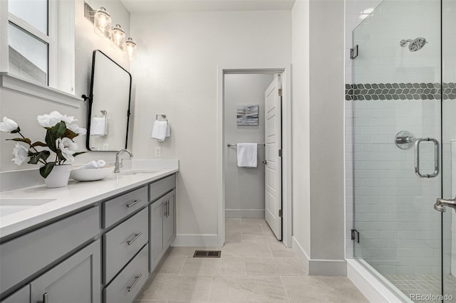 2052 Alcott Way, Broomfield, CO 80023 - full bath with double vanity, a stall shower, tile patterned floors, and baseboards