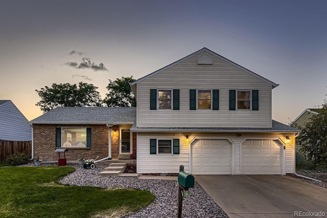 tri-level home with a garage, brick siding, fence, concrete driveway, and a front yard