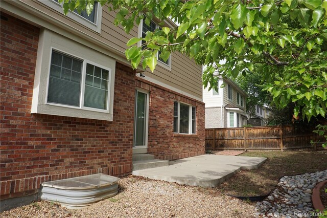 20630 E Hamilton Ave, Aurora, CO 80013 - entrance to property with a patio and brick siding