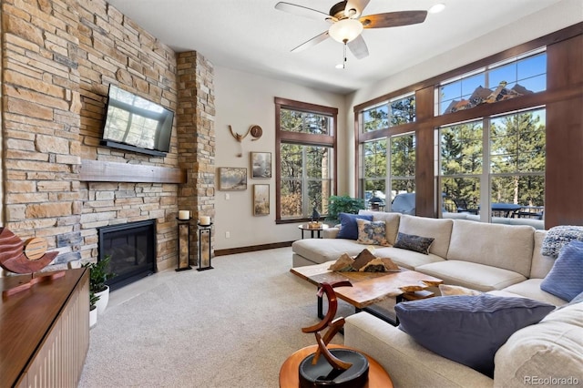 living room with ceiling fan, light carpet, and a fireplace