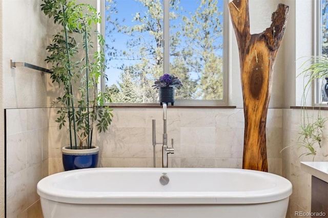 bathroom with tile walls and a bathing tub